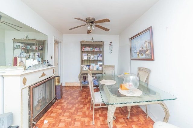 dining room featuring ceiling fan and parquet flooring