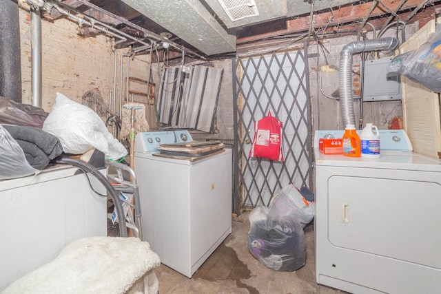 clothes washing area with electric panel and washing machine and clothes dryer