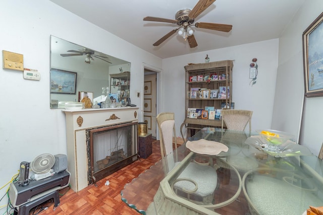 dining area featuring a fireplace and parquet floors