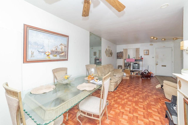 dining room featuring parquet floors and ceiling fan