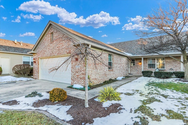 view of snowy exterior featuring a garage