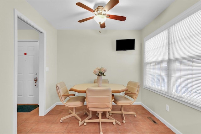 tiled dining area featuring ceiling fan