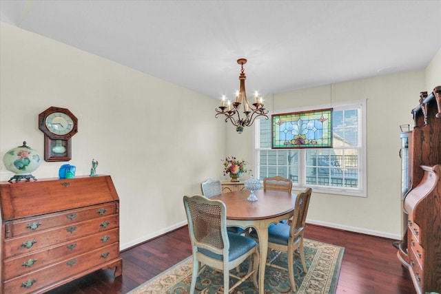 dining room featuring dark hardwood / wood-style floors and a notable chandelier