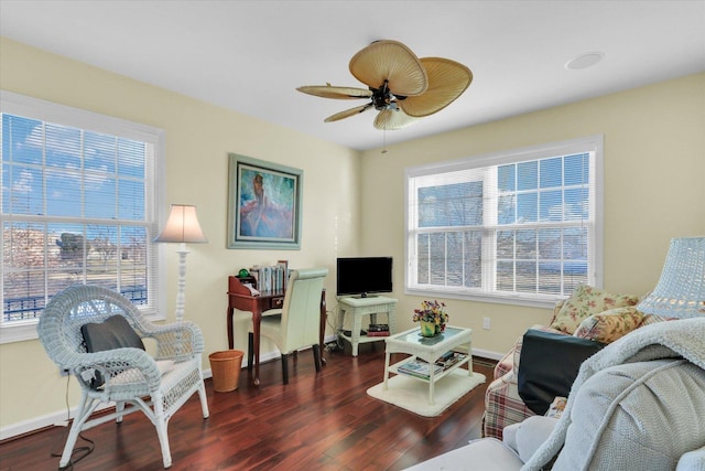 living room featuring dark wood-type flooring and ceiling fan