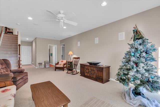 carpeted living room featuring ceiling fan