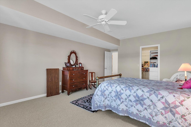 carpeted bedroom featuring a spacious closet, ceiling fan, and a closet