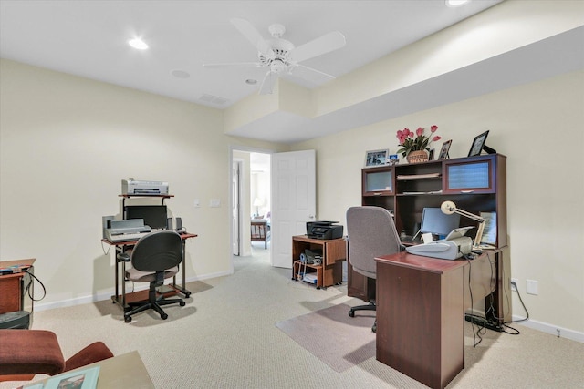 home office featuring light carpet and ceiling fan