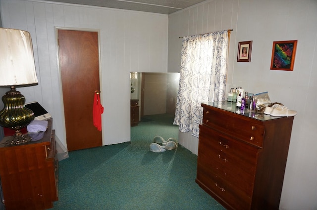 carpeted bedroom with wood walls