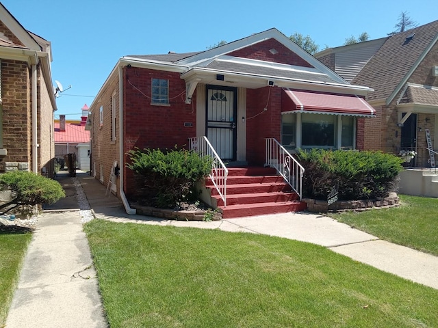 bungalow-style home featuring a front yard