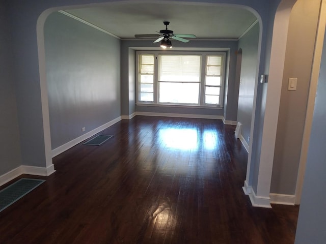 unfurnished room featuring dark hardwood / wood-style flooring, ceiling fan, and ornamental molding