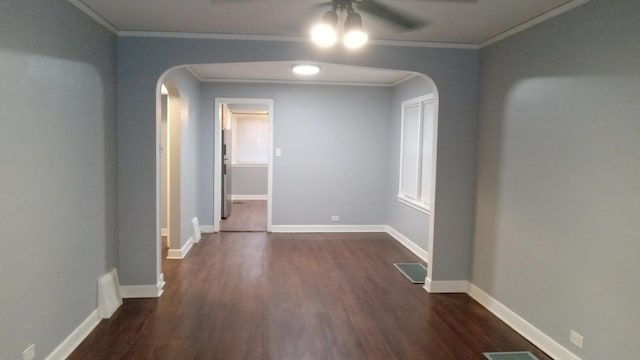 unfurnished room featuring crown molding, dark wood-type flooring, and ceiling fan