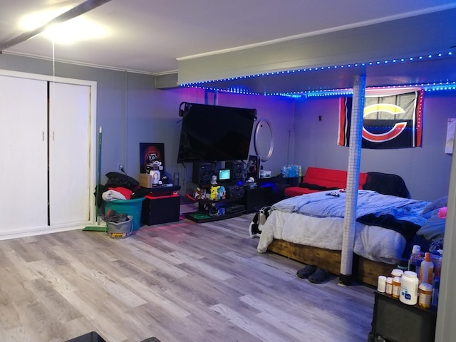 bedroom featuring hardwood / wood-style floors and ornamental molding