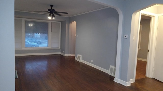 spare room featuring crown molding, ceiling fan, and dark hardwood / wood-style flooring