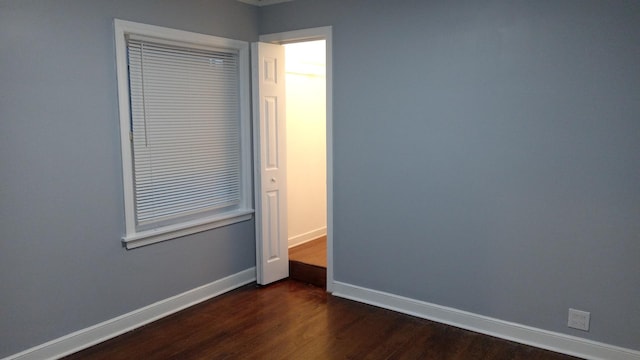 spare room featuring dark hardwood / wood-style floors