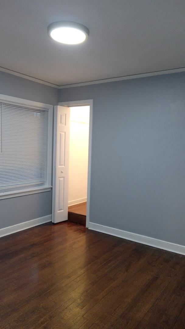 unfurnished room with dark wood-type flooring