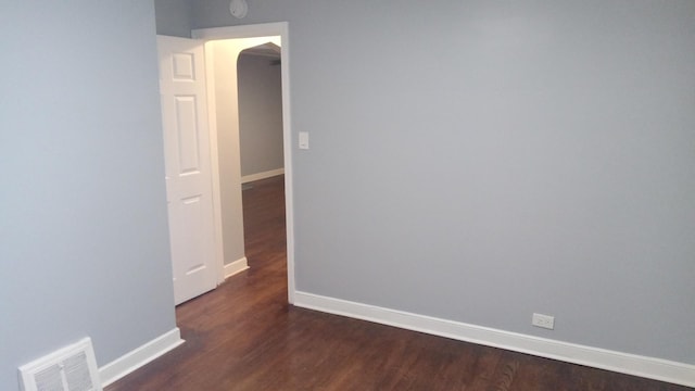 spare room featuring dark hardwood / wood-style flooring