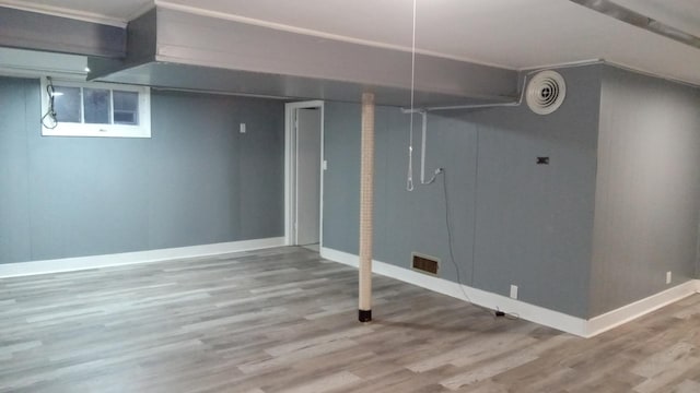 basement with hardwood / wood-style floors