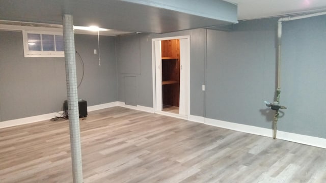 basement with hardwood / wood-style flooring