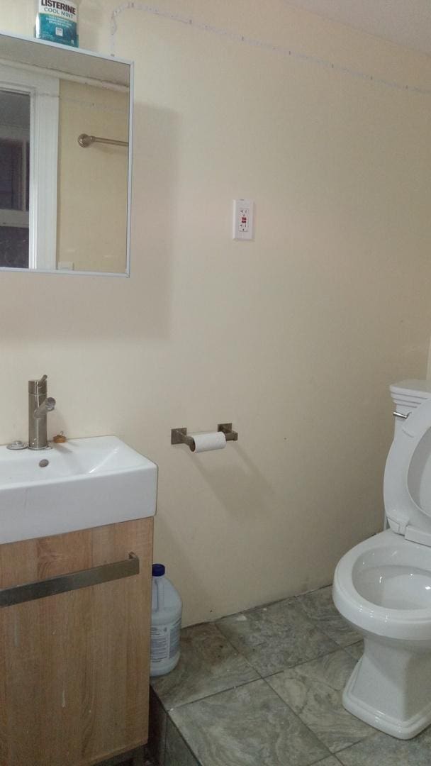 bathroom with tile patterned floors, vanity, and toilet