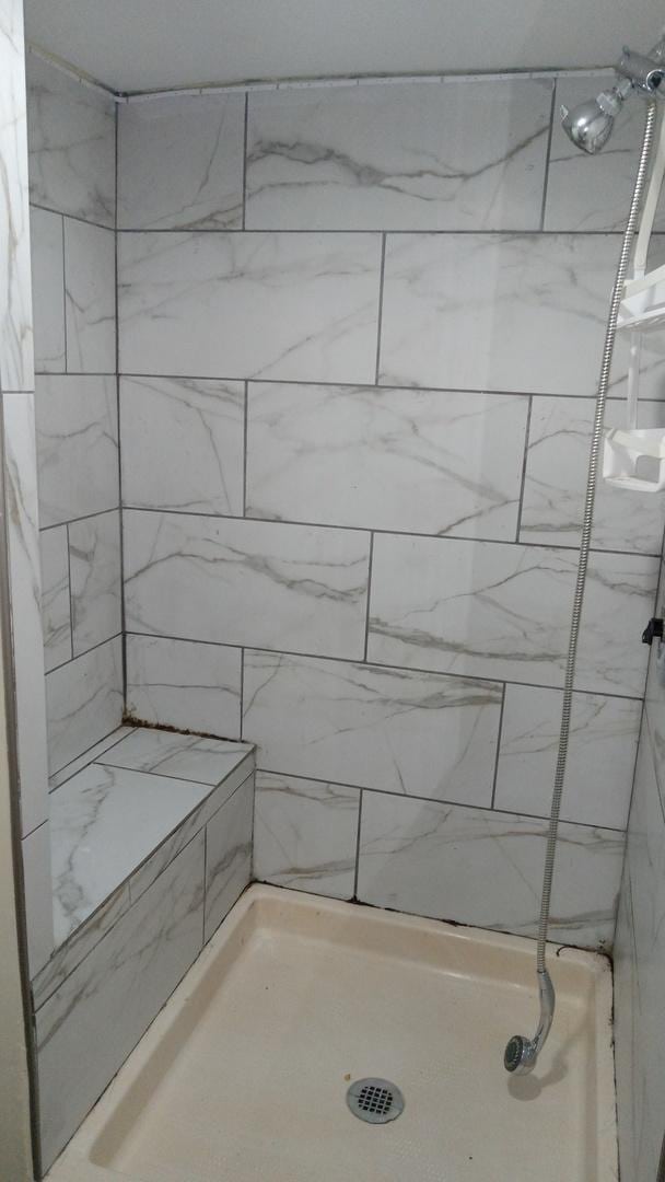 bathroom with a tile shower