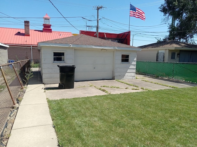 back of property featuring an outdoor structure, a lawn, and a garage