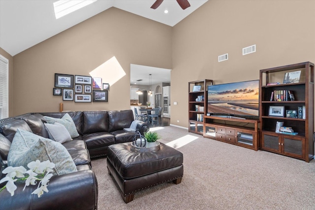 living room featuring high vaulted ceiling, ceiling fan, and carpet