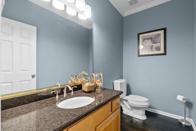 bathroom with vanity, crown molding, toilet, and hardwood / wood-style flooring