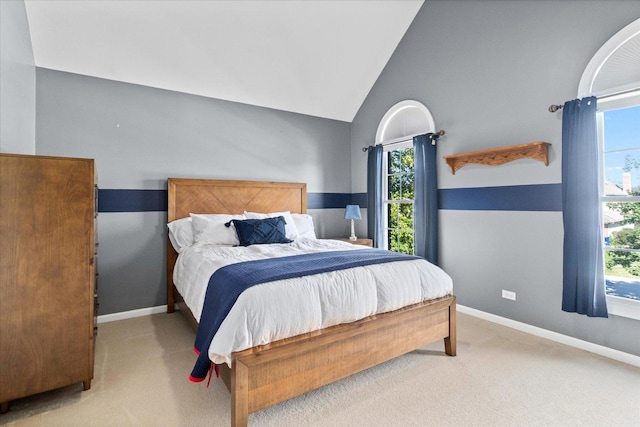 bedroom featuring light carpet and vaulted ceiling