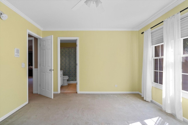 carpeted spare room with ornamental molding and ceiling fan