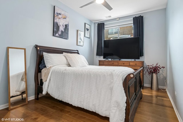 bedroom featuring dark hardwood / wood-style floors and ceiling fan