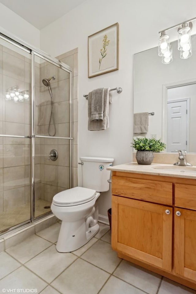 bathroom with walk in shower, vanity, toilet, and tile patterned flooring