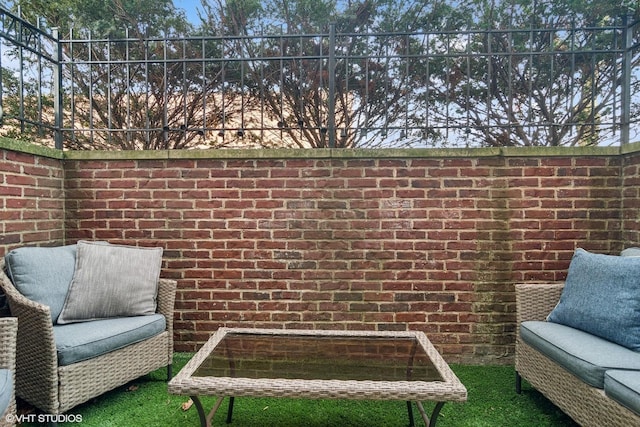 living area featuring brick wall