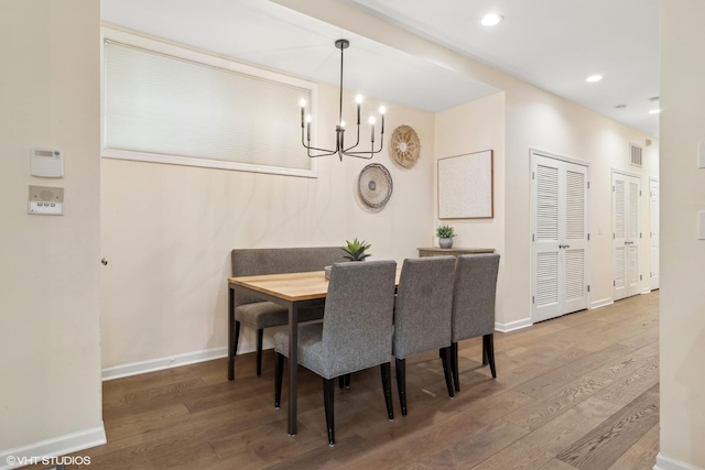 dining room featuring an inviting chandelier and hardwood / wood-style floors