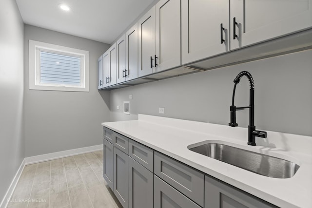 kitchen featuring sink and gray cabinetry