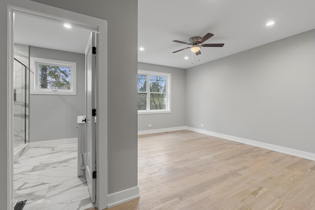 entrance foyer with ceiling fan and light hardwood / wood-style flooring