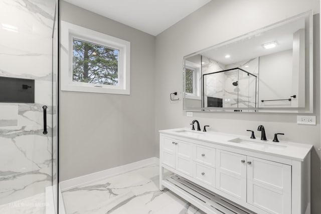 bathroom featuring a shower with door and vanity