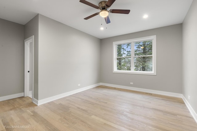 empty room with light wood-type flooring and ceiling fan