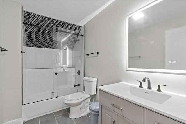 full bathroom with tile patterned floors, shower / bath combination with glass door, vanity, and toilet