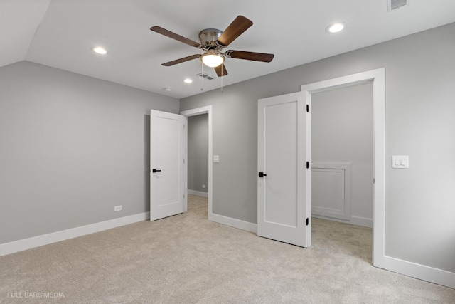 unfurnished bedroom with light carpet, lofted ceiling, and ceiling fan