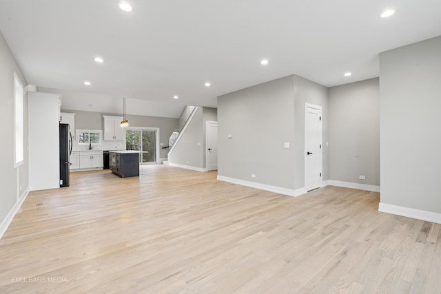 unfurnished living room with light hardwood / wood-style flooring