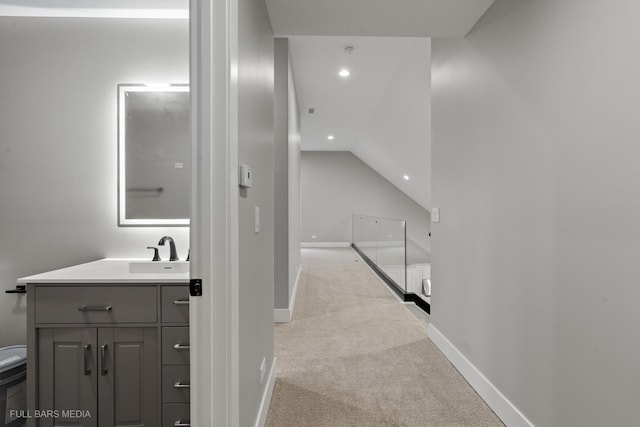 bathroom featuring lofted ceiling and vanity