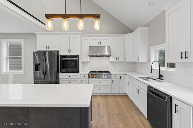 kitchen featuring decorative light fixtures, white cabinets, and stainless steel appliances