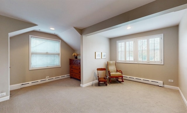 living area with baseboard heating, vaulted ceiling, and light colored carpet