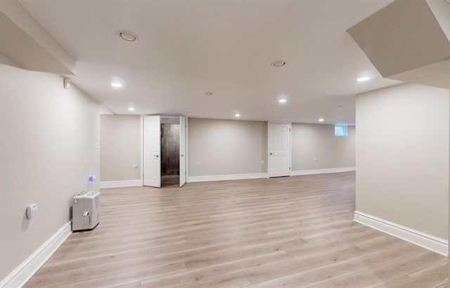 basement with light hardwood / wood-style flooring