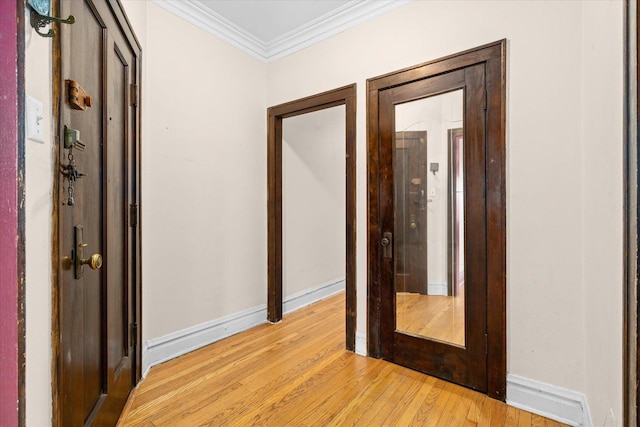 hall featuring light hardwood / wood-style floors and ornamental molding