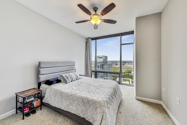 bedroom featuring ceiling fan, carpet flooring, and floor to ceiling windows