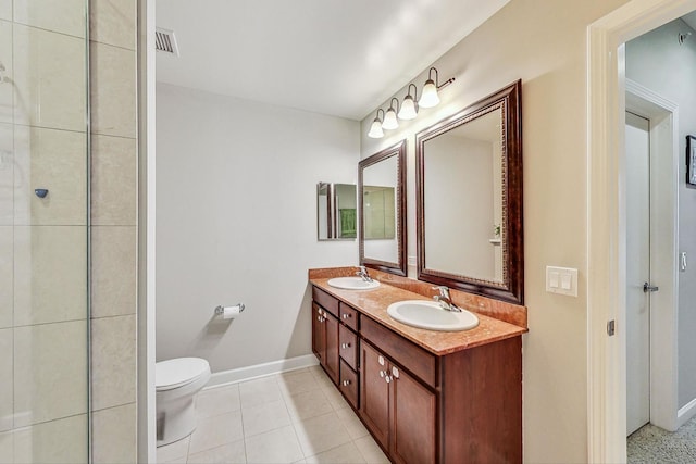 bathroom featuring toilet, tile patterned floors, and vanity