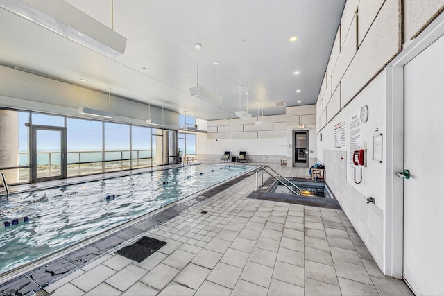 view of swimming pool with a water view