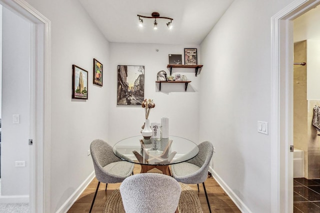 dining space with dark hardwood / wood-style floors