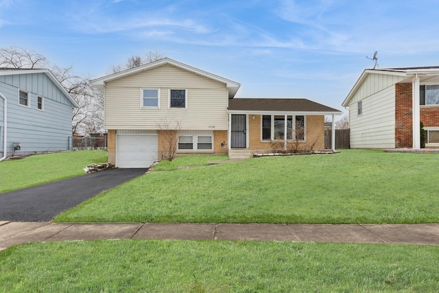 tri-level home with a garage and a front lawn